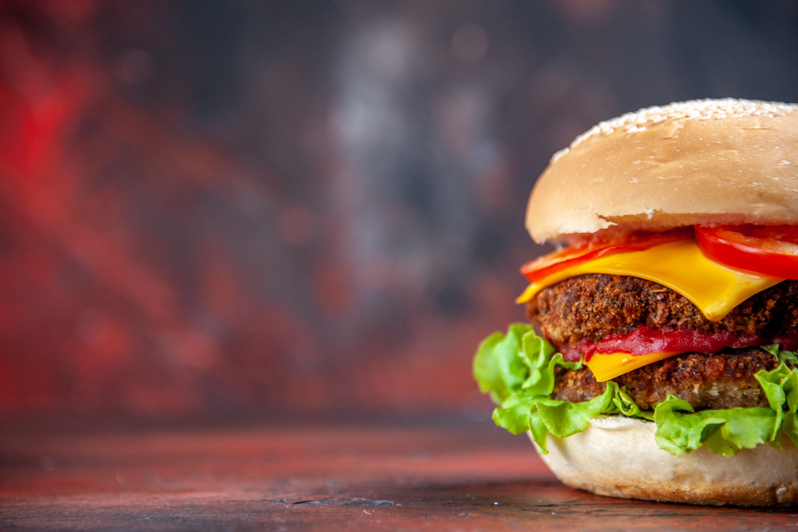 front-view-tasty-meat-burger-with-cheese-salad-dark-background
